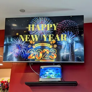 a tv mounted on a wall with fireworks in the background