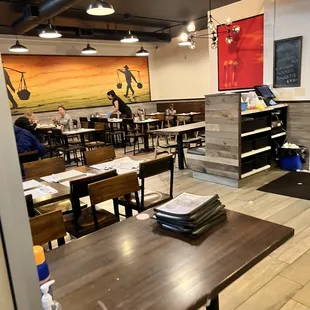 people sitting at tables in a restaurant