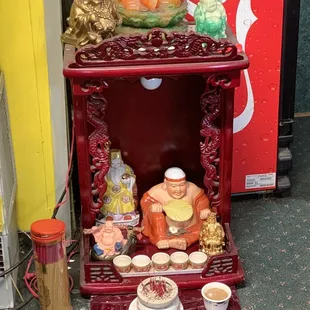 a small shrine with a buddha statue