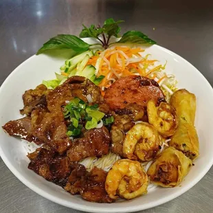 Vermicelli noodles with grilled pork, shrimp, pork sausages, and egg roll