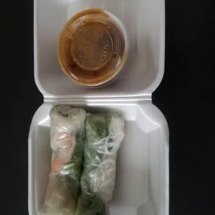a container of food and a container of dipping sauce