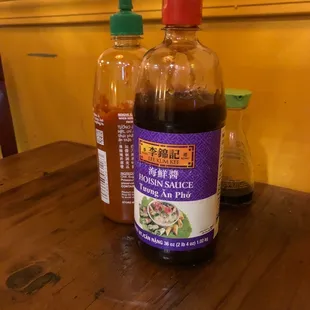 two bottles of sauce on a table