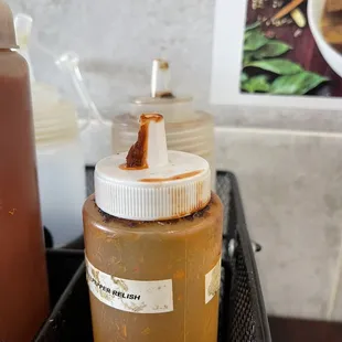 a container of mustard and ketchup