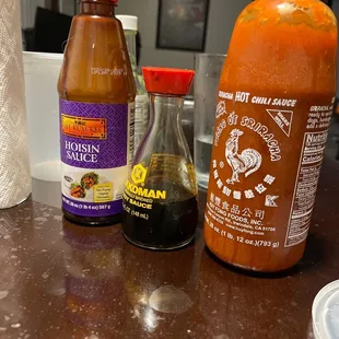 two bottles of hot sauce and a bottle of hot sauce