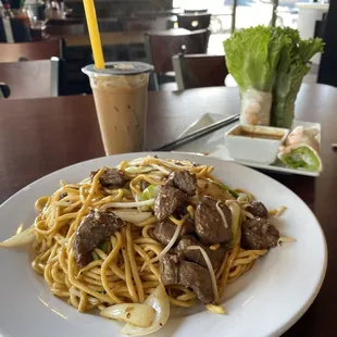 112. Garlic Noodles with Beef upfront. B11. Vietnamese Coffee & A4. Fresh Spring Rolls with Pork and Shrimp at back