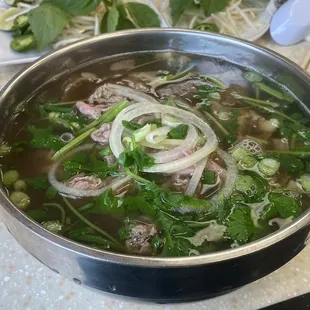 a pot of soup with meat and vegetables