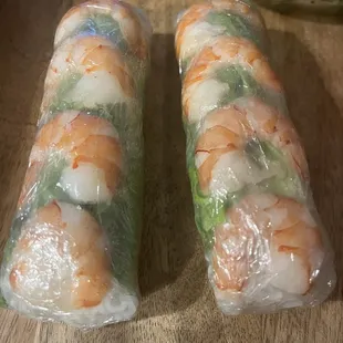 two rolls of shrimp wrapped in plastic wrap