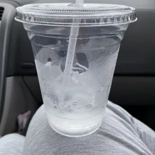 a drink in a plastic cup with a straw