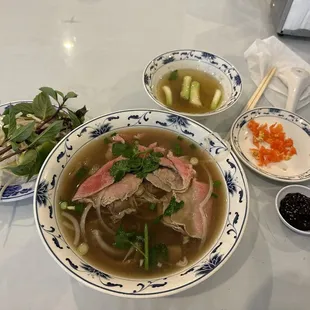 a bowl of soup with meat and vegetables
