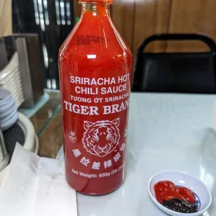 ... other tables have the Tiger Brand sriracha sauce.