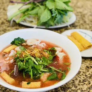 a bowl of soup and a plate of vegetables