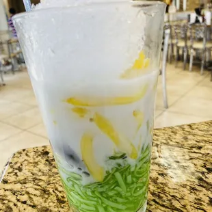 a glass of ice cream with lemon slices