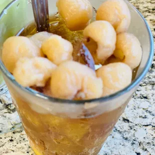 a glass of tea with a spoon in it