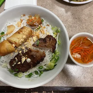 Vermicelli bowl with beef and an egg roll