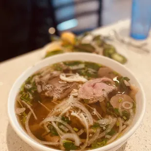 a bowl of soup with meat and vegetables