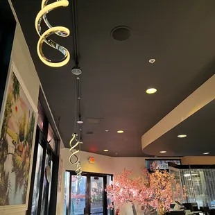 Interesting light fixtures, attractive, well lit and clean venue with booths and tables