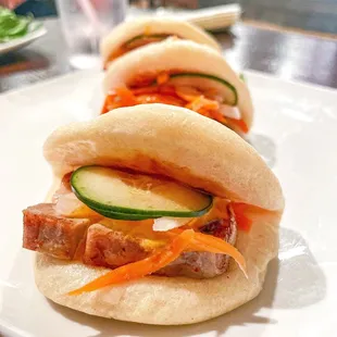 three buns with meat and vegetables