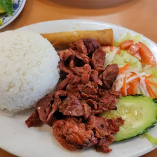 a plate of rice, meat and vegetables