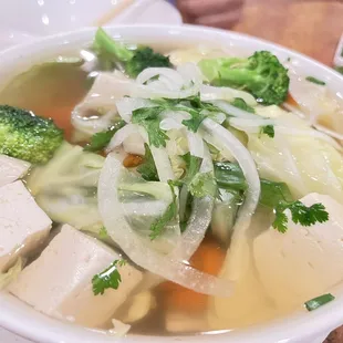 a bowl of soup with tofu and vegetables