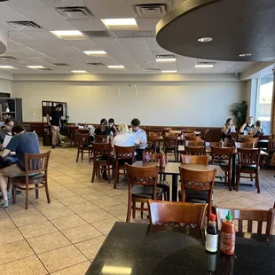 people sitting at tables in a restaurant