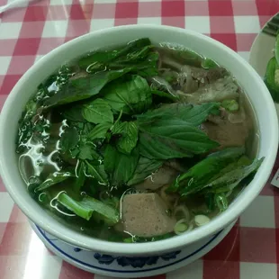 a bowl of soup with meat and vegetables
