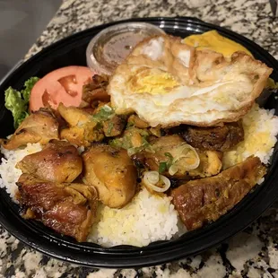 Charbroiled lemon grass chicken with egg cake and fried egg on crushed rice