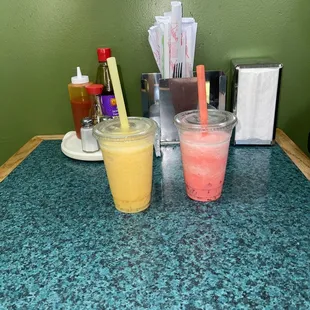 Fresh made bubble tea (mango and Watermelon shown). Flavors of fillings are: Tapioca, Lychee, coconut and Rainbow.