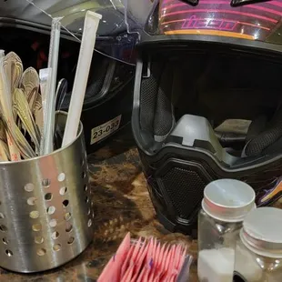 a helmet, toothbrushes and other items on a counter