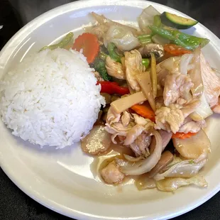 Stir fry chicken and vegetables with a side of white rice.