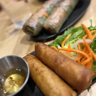 a plate of food and a bowl of dipping sauce