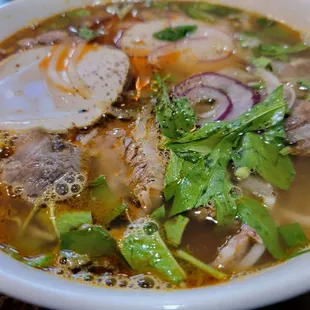 a bowl of soup with meat and vegetables