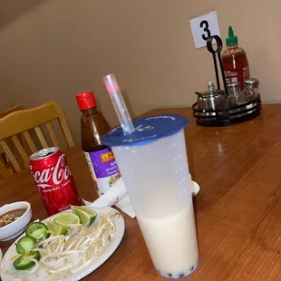 a glass of milk and a plate of noodles