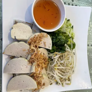 a plate of chicken, noodles, and sauce