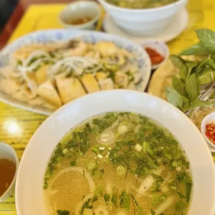a bowl of soup and a plate of noodles