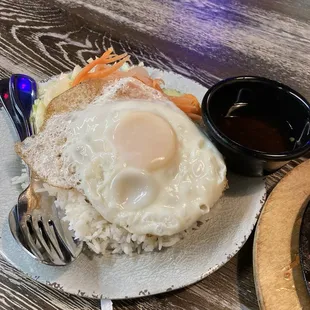 Beef short ribs came with this plate of rice, lettuce, carrots, an egg and sweet sauce.