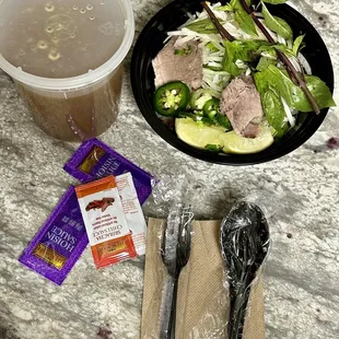 Pho dac biet to go! I love that they have to go soup spoons.