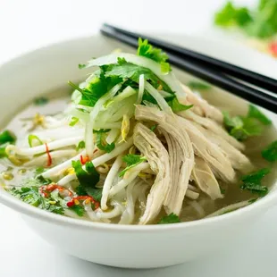 a bowl of soup and chopsticks