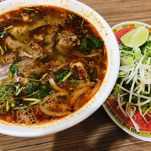 a bowl of soup and a plate of broccoli