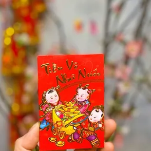 a person holding a red packet