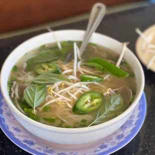 a bowl of soup and a plate of noodles