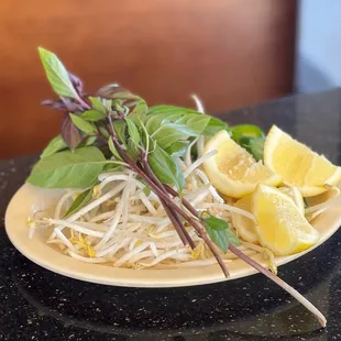 a plate of noodles and lemon slices