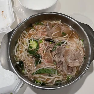 Unpacked takeout after adding broth #42 pho rice noodle soup with steak, flank and brisket.