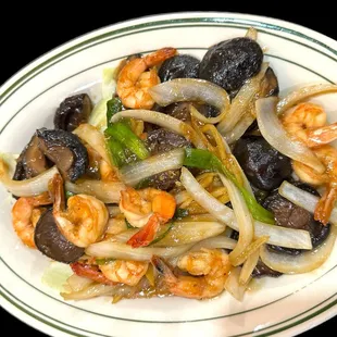 a plate of stir fried shrimp and vegetables