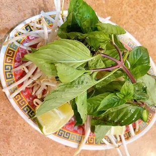 a plate of noodles and greens