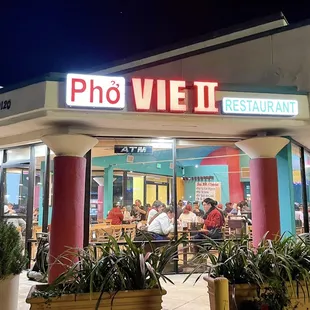A bright and busy pho restaurant during the midnight.