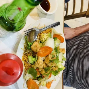 a person sitting at a table with a plate of food