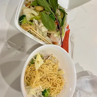 two bowls of noodles and chopsticks
