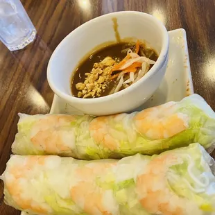a bowl of soup and two rolls on a plate