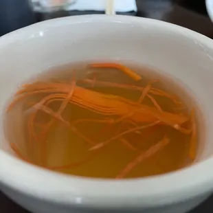 a bowl of soup with carrots