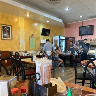 people sitting at tables in a restaurant